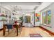 Bright dining area with a view, hardwood floors, and an open connection to the kitchen at 740 Carr St, Lakewood, CO 80214