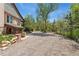 Long gravel driveway leading to a beautiful home surrounded by mature trees at 740 Carr St, Lakewood, CO 80214