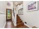 Entryway with tile floors, wooden door, staircase, and iron railing at 740 Carr St, Lakewood, CO 80214