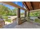 Inviting front porch featuring stone columns, comfortable seating, and a view of the surrounding greenery at 740 Carr St, Lakewood, CO 80214