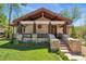 Charming home showcasing a welcoming front porch with stone accents and a well-manicured lawn at 740 Carr St, Lakewood, CO 80214