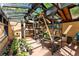 Bright greenhouse with glass ceiling, shelving for plants and concrete floor creating a functional space at 740 Carr St, Lakewood, CO 80214