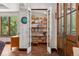 Hallway with built-in bookshelves, display shelving and rich trim details at 740 Carr St, Lakewood, CO 80214