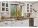 Bright kitchen featuring stainless steel appliances, granite countertops, undermount sink, and a large window with a wooded view at 740 Carr St, Lakewood, CO 80214