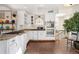 Spacious kitchen with white cabinets, stainless appliances, tile floor, granite counters, and eat-in area at 740 Carr St, Lakewood, CO 80214