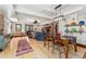 Open-concept living space with hardwood floors, a stone fireplace, and dining area at 740 Carr St, Lakewood, CO 80214