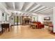 Open living room with stone fireplace, wood floors, beamed ceiling, and lots of natural light at 740 Carr St, Lakewood, CO 80214