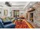 Cozy living room featuring a stone fireplace, hardwood floors, and comfortable seating at 740 Carr St, Lakewood, CO 80214
