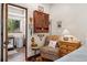 Bedroom featuring hardwood floors, dresser, bedside table, decor and en suite bathroom at 740 Carr St, Lakewood, CO 80214