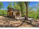 Charming building surrounded by nature, featuring unique doors, and a cozy outdoor area for relaxation at 740 Carr St, Lakewood, CO 80214