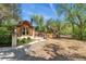 Charming outbuilding with unique architectural details and surrounding greenery, perfect for a creative space at 740 Carr St, Lakewood, CO 80214