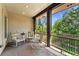 Relax on this covered patio with decorative chairs and view of the surrounding wooded area at 740 Carr St, Lakewood, CO 80214