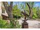 Exterior view of yard with decorative sculpture, landscaping and gravel driveway at 740 Carr St, Lakewood, CO 80214