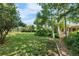 Large grassy backyard with mature trees and landscaping, perfect for outdoor activities at 1315 Tipperary St, Boulder, CO 80303