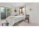 Cozy bedroom with a sliding glass door to a deck, plants, and neutral décor at 1315 Tipperary St, Boulder, CO 80303