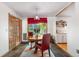 Dining room featuring slate floors, wood table with chairs, and a window with bright red blinds at 1315 Tipperary St, Boulder, CO 80303