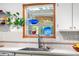 Bright kitchen featuring a modern faucet and a window displaying colorful glassware at 1315 Tipperary St, Boulder, CO 80303