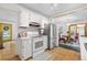 Bright kitchen featuring white cabinetry, stainless steel appliances, and light hardwood floors at 1315 Tipperary St, Boulder, CO 80303
