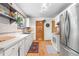 Bright kitchen featuring white cabinetry, stainless steel appliances, and light hardwood floors at 1315 Tipperary St, Boulder, CO 80303