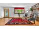 Bright living room with hardwood floors, large window, brick fireplace, and stylish furnishings at 1315 Tipperary St, Boulder, CO 80303