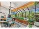 Inviting sunroom with a wood-burning stove, skylights, and walls of windows to let in lots of light at 1315 Tipperary St, Boulder, CO 80303