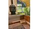Intimate sunroom with wood-burning stove and plants, designed for relaxation and enjoying natural light at 1315 Tipperary St, Boulder, CO 80303