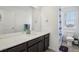 Bright bathroom featuring a wide mirror and a shower with blue accents at 8073 Mt Lincoln Rd, Littleton, CO 80125