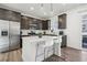 Modern kitchen with stainless steel appliances, a center island, and dark cabinets at 8073 Mt Lincoln Rd, Littleton, CO 80125