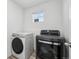 Bright laundry room featuring a newer washer and dryer, plus a window for natural light at 8073 Mt Lincoln Rd, Littleton, CO 80125