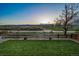 Manicured lawn in the backyard with a split rail fence and open space view at 9505 Painted Canyon Cir, Highlands Ranch, CO 80129