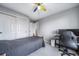 Comfortable bedroom with neutral walls, a closet, and ceiling fan with colorfully painted blades at 9505 Painted Canyon Cir, Highlands Ranch, CO 80129
