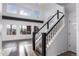Bright entryway featuring a staircase with black banisters and large windows offering scenic views at 9505 Painted Canyon Cir, Highlands Ranch, CO 80129