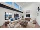 Airy living room with high ceilings, modern furnishings, and large windows showcasing mountain views at 9505 Painted Canyon Cir, Highlands Ranch, CO 80129