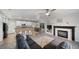 Open-concept living area connecting the kitchen and living room with a cozy fireplace at 9505 Painted Canyon Cir, Highlands Ranch, CO 80129
