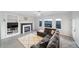 Comfortable living room with a fireplace, large windows, and serene views of the surrounding landscape at 9505 Painted Canyon Cir, Highlands Ranch, CO 80129