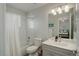 Hall bath features shower-tub combination, updated vanity and bright light fixture at 14032 Park Cove Dr, Broomfield, CO 80023