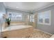 Luxurious bathroom featuring a soaking tub, glass enclosed shower, and shuttered windows at 14032 Park Cove Dr, Broomfield, CO 80023