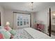 Charming bedroom with four-poster bed, chandelier, and plantation shutters at 14032 Park Cove Dr, Broomfield, CO 80023