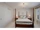 Bright bedroom featuring a four-poster bed, chandelier, and a closet at 14032 Park Cove Dr, Broomfield, CO 80023