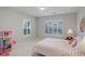 Well-lit room with plantation shutters, featuring a doll house and a bed with floral design at 14032 Park Cove Dr, Broomfield, CO 80023