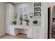 Eat-in kitchen desk area with quartz counters and stainless refrigerator at 14032 Park Cove Dr, Broomfield, CO 80023