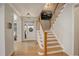 Elegant foyer with hardwood floors, a staircase, and a view into the living room, creating a welcoming entrance at 14032 Park Cove Dr, Broomfield, CO 80023