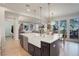 Open-concept kitchen island with a farmhouse sink and pendant lighting at 14032 Park Cove Dr, Broomfield, CO 80023