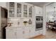 Bright kitchen with glass-front cabinets displaying fine dishware and stainless steel oven at 14032 Park Cove Dr, Broomfield, CO 80023