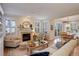 Open-concept living room with fireplace, leading to dining area with natural light and hardwood floors at 14032 Park Cove Dr, Broomfield, CO 80023