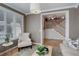 Bright living room featuring large windows with shutters and an open doorway to the foyer with wooden stairs at 14032 Park Cove Dr, Broomfield, CO 80023