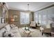 Cozy living room with neutral tones, plantation shutters, and comfortable seating, perfect for relaxation at 14032 Park Cove Dr, Broomfield, CO 80023