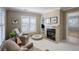 Cozy living room features a fireplace with marble surround and built in shelving at 14032 Park Cove Dr, Broomfield, CO 80023