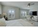 Bright main bedroom featuring plantation shutters, ceiling fan, and comfortable seating area at 14032 Park Cove Dr, Broomfield, CO 80023