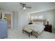 Serene bedroom with neutral tones, plantation shutters, and a cozy bench at the foot of the bed at 14032 Park Cove Dr, Broomfield, CO 80023